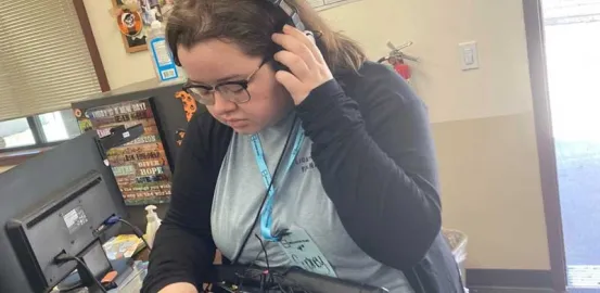 a girl wearing a headset and working in production