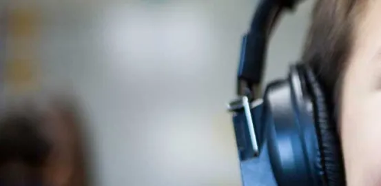 Child wearing headphones to help with auditory processing disorder