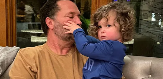 Dave and his grandson Hudson touching his face