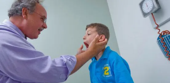 Dr. Tim Buie examining a child in his office