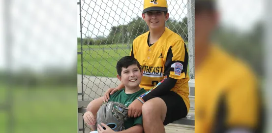 Dylan James Strode and his brother in their baseball uniforms