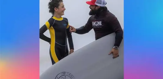 Gnome Surf instructor talking to a young surfer boy