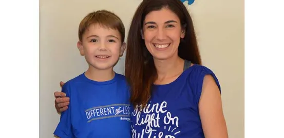 Mandy Farmer and her son wearing autism awareness shirts