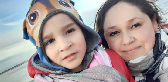 Maria and her son Nazareno on the beach in winter