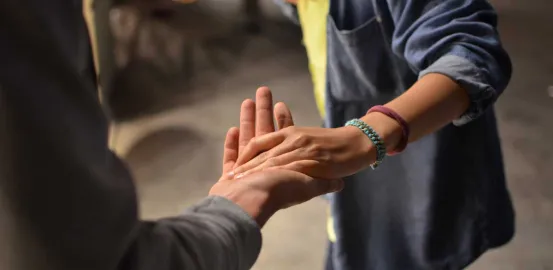 People holding hands to show support