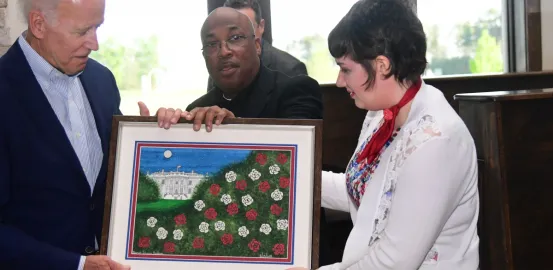 Sarah Redding sharing her artwork with President Biden