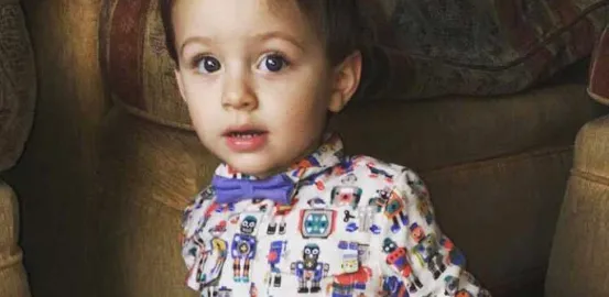 Toddler wearing a bowtie and shirt with robots