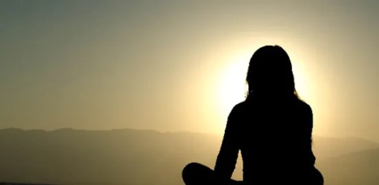 Woman's silhouette watching the sunset