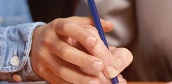 a teacher helping a child learn to write