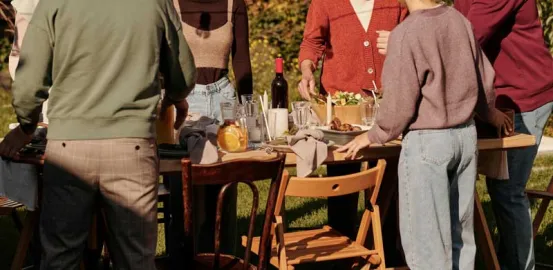 a group of people around an outdoor dining table