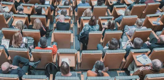 adults sitting in an auditorium