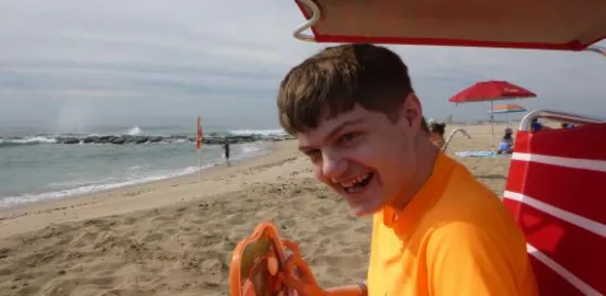 an autistic boy at the beach