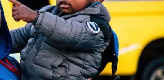 baby pointing at a car outside