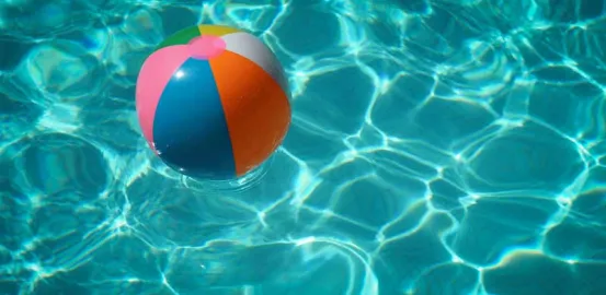 blow up beach ball floating in a pool