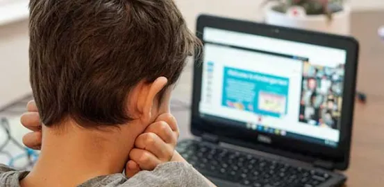 child looking at a laptop during an online class