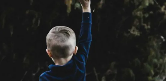 child outside throwing things