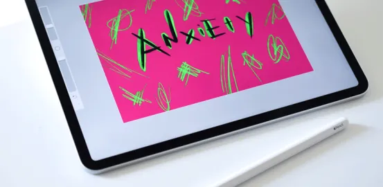 iPad with the paint app open to a design that says 'anxiety'