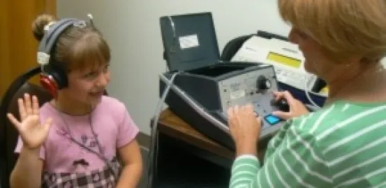 young girl during a hearing test_courtesy of michdepthealth