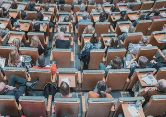 adults sitting in an auditorium