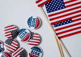 Three American flags with buttons of flags and the word "vote"