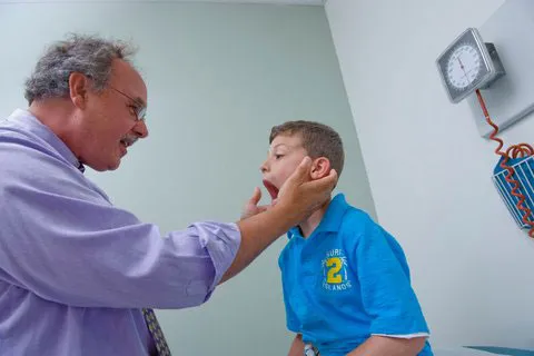 Dr. Tim Buie examining a child in his office