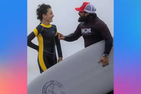 Gnome Surf instructor talking to a young surfer boy