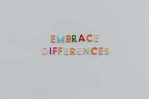 Letter magnets on a refrigerator that spell out Embrace Differences