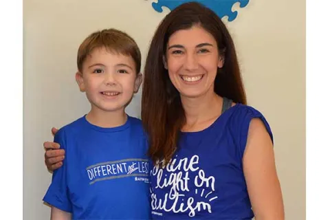 Mandy Farmer and her son wearing autism awareness shirts