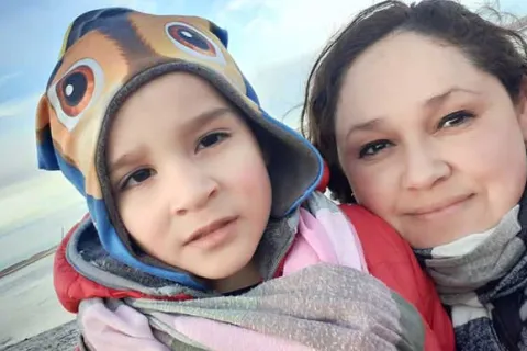 Maria and her son Nazareno on the beach in winter