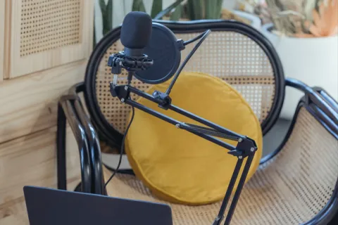 Podcast set up with microphone, laptop and chair