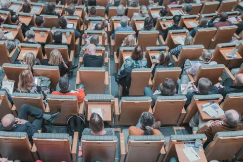 adults sitting in an auditorium