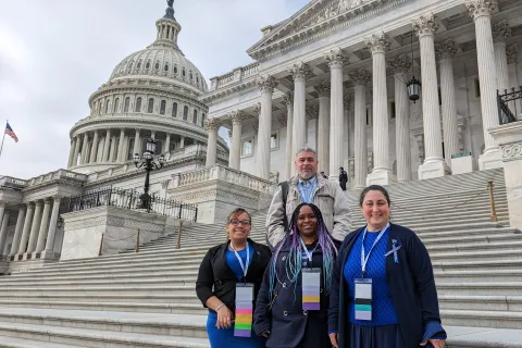 one male and three female advocates standing on the steps of the US Capitol with building dome in the background