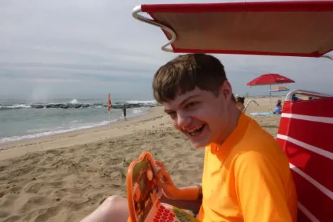 an autistic boy at the beach