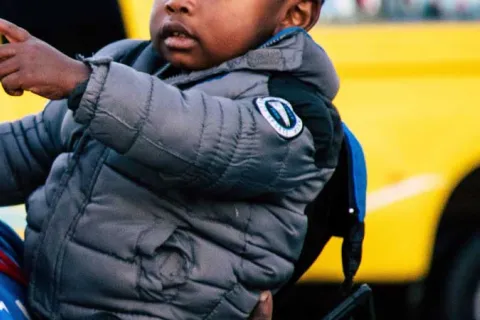 baby pointing at a car outside