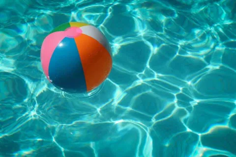 blow up beach ball floating in a pool