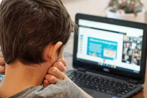 child looking at a laptop during an online class