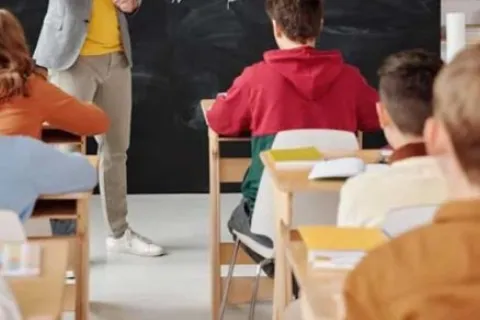 children in a classroom sitting at desks