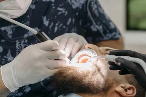 man with a beard getting dental work done