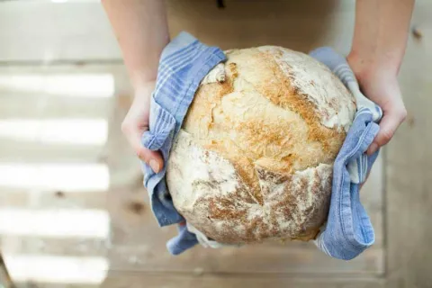 someone holding fresh baked bread