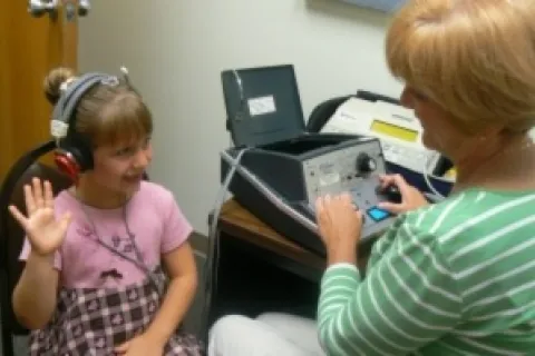 young girl during a hearing test_courtesy of michdepthealth