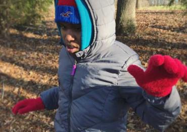 Bailey outside wearing winter gloves, hat and jacket