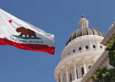 California state flag next to capitol dome