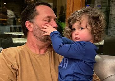 Dave and his grandson Hudson touching his face