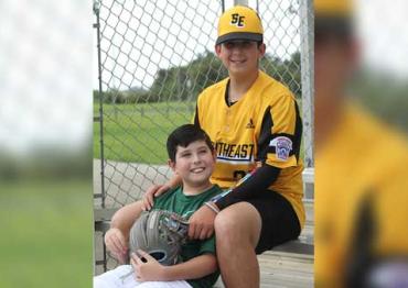 Dylan James Strode and his brother in their baseball uniforms