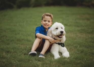 Jacob and Reid, a little boy hugging his dog