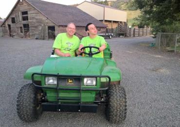 Jeff and his son Jonathan on a tractor