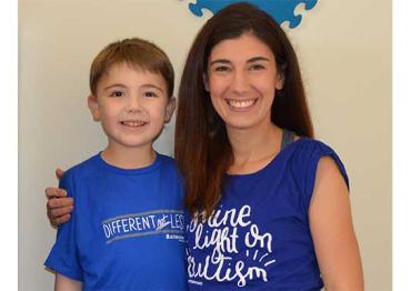 Mandy Farmer and her son wearing autism awareness shirts