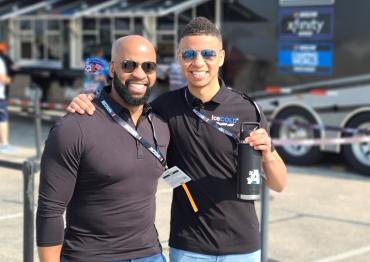 NASCAR driver Armani Williams and his dad, Del, outside wearing sunglasses