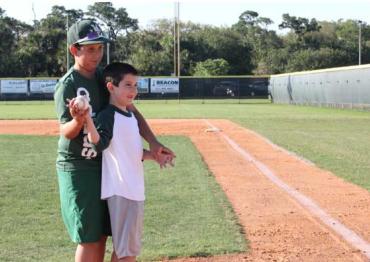 Two brothers stand to throw out the first pitch