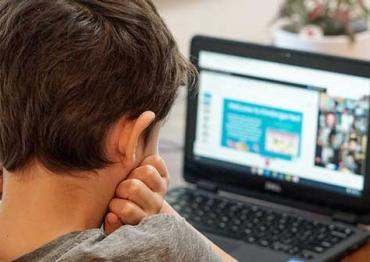 child looking at a laptop during an online class